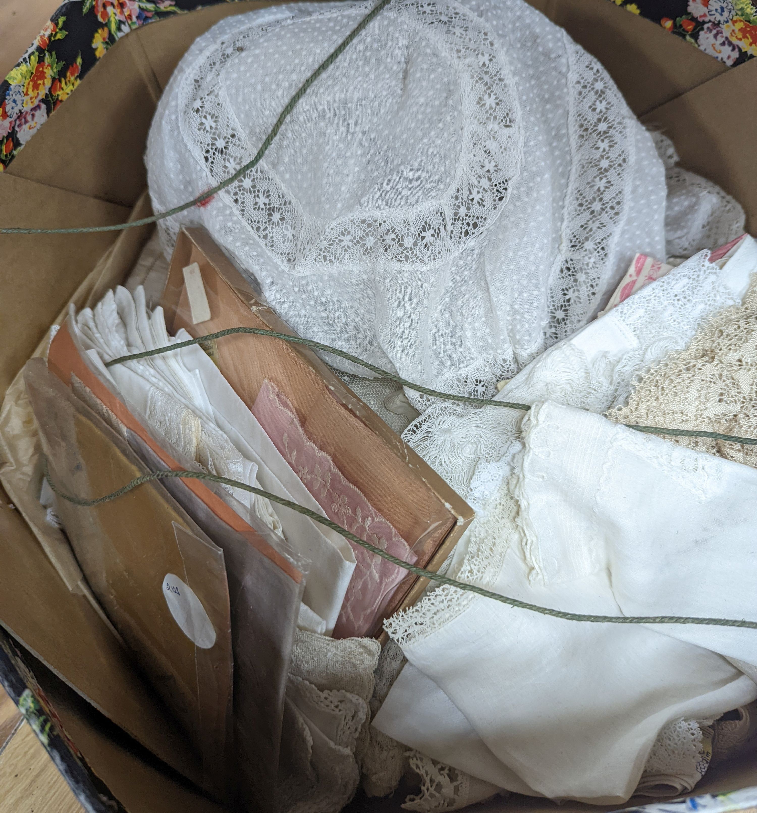 A collection of lady’s and baby's lace bonnets, various hankies and a cream silk embroidered skirt.